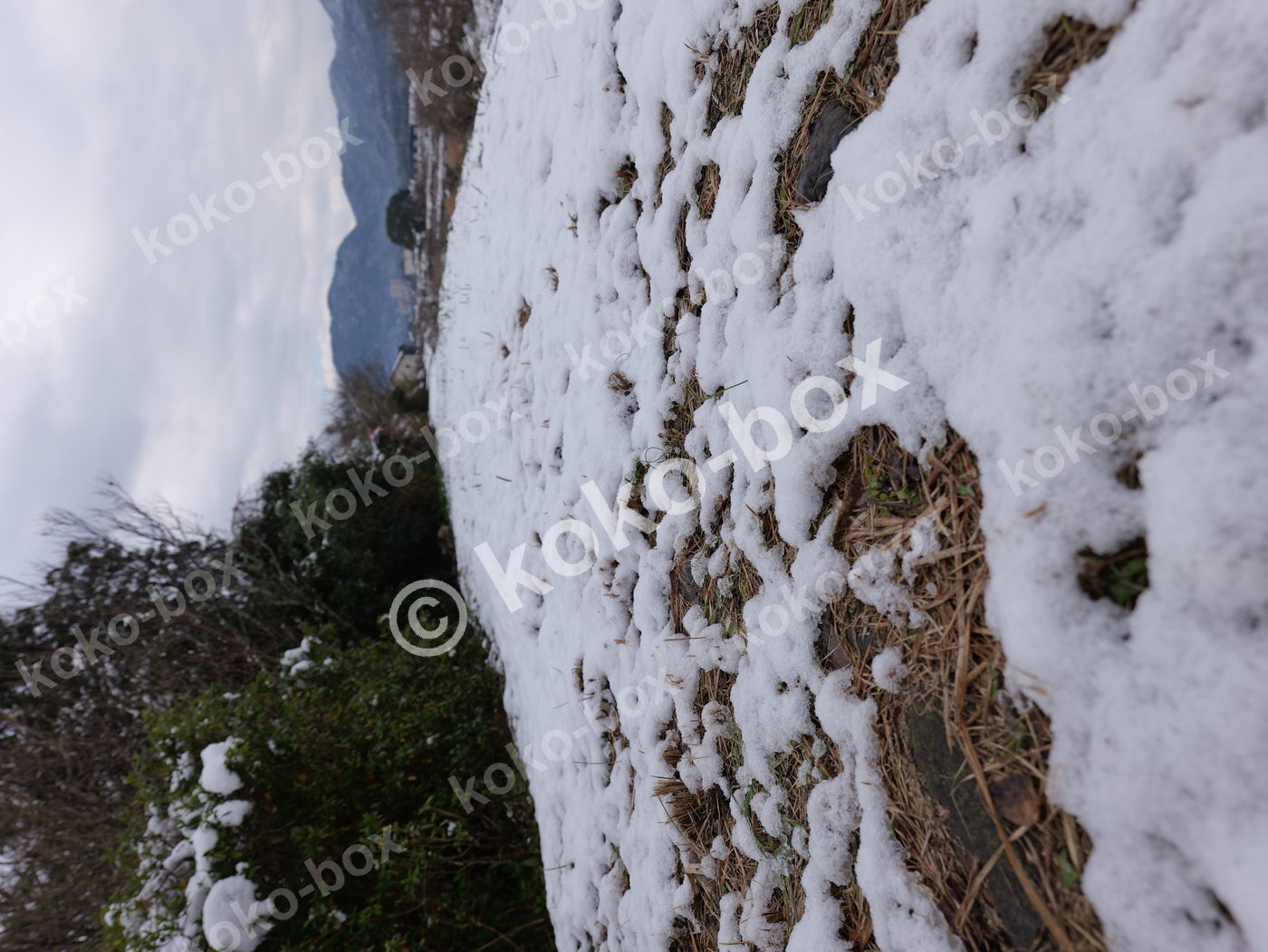 雪の畦道と里山の風景 横位置写真素材